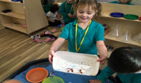 Pre-Prep pupil with a sieve