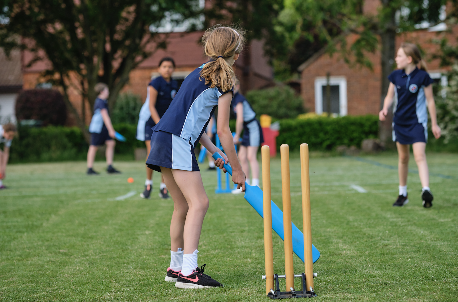 Image of pupils playing cricket to illustrate link to 'Dame Bradbury's Sports Fixtures and Results' page