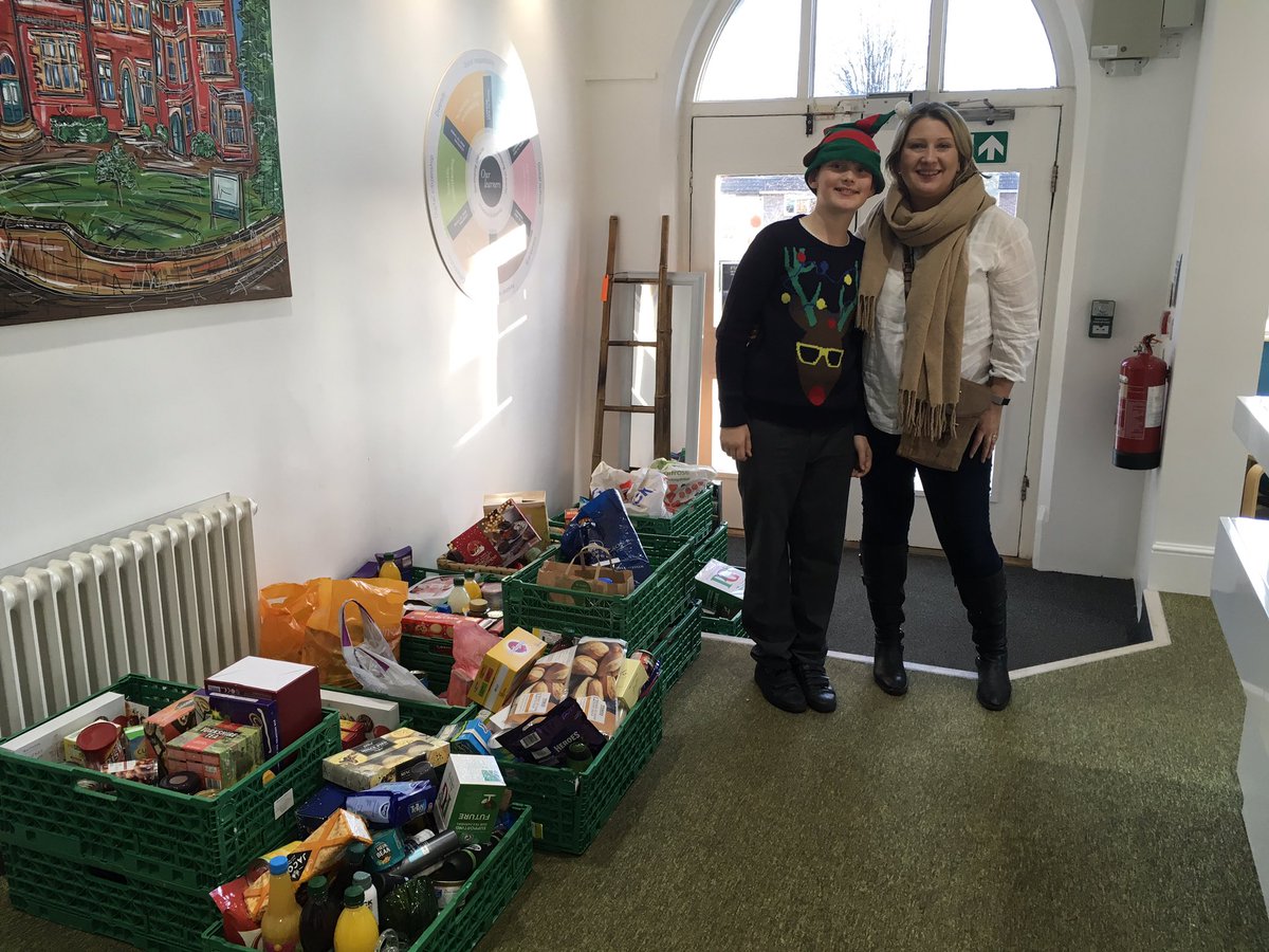 Henry and his mum next to all the food that was collected