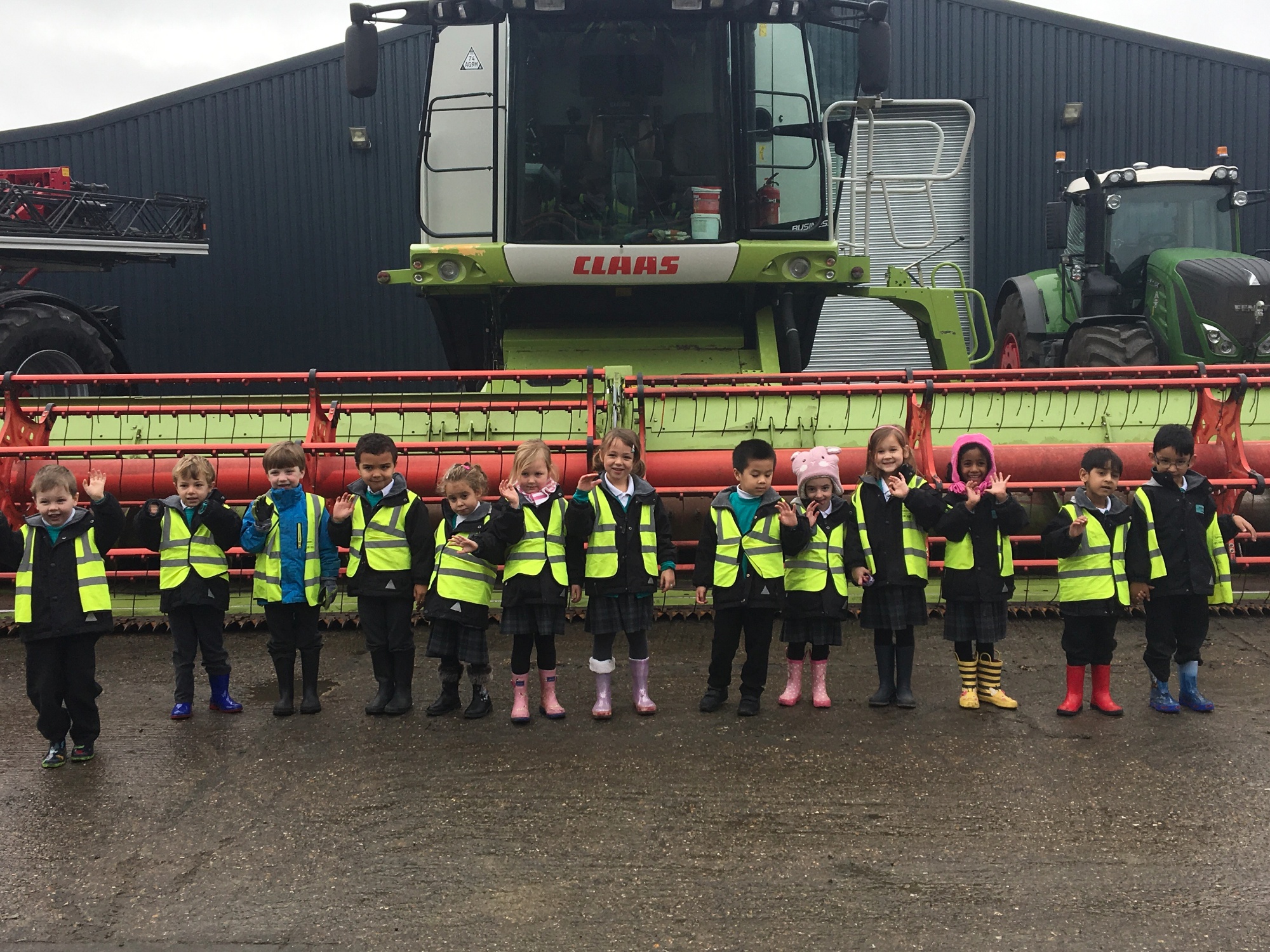 Waving in front of a  combine harvester