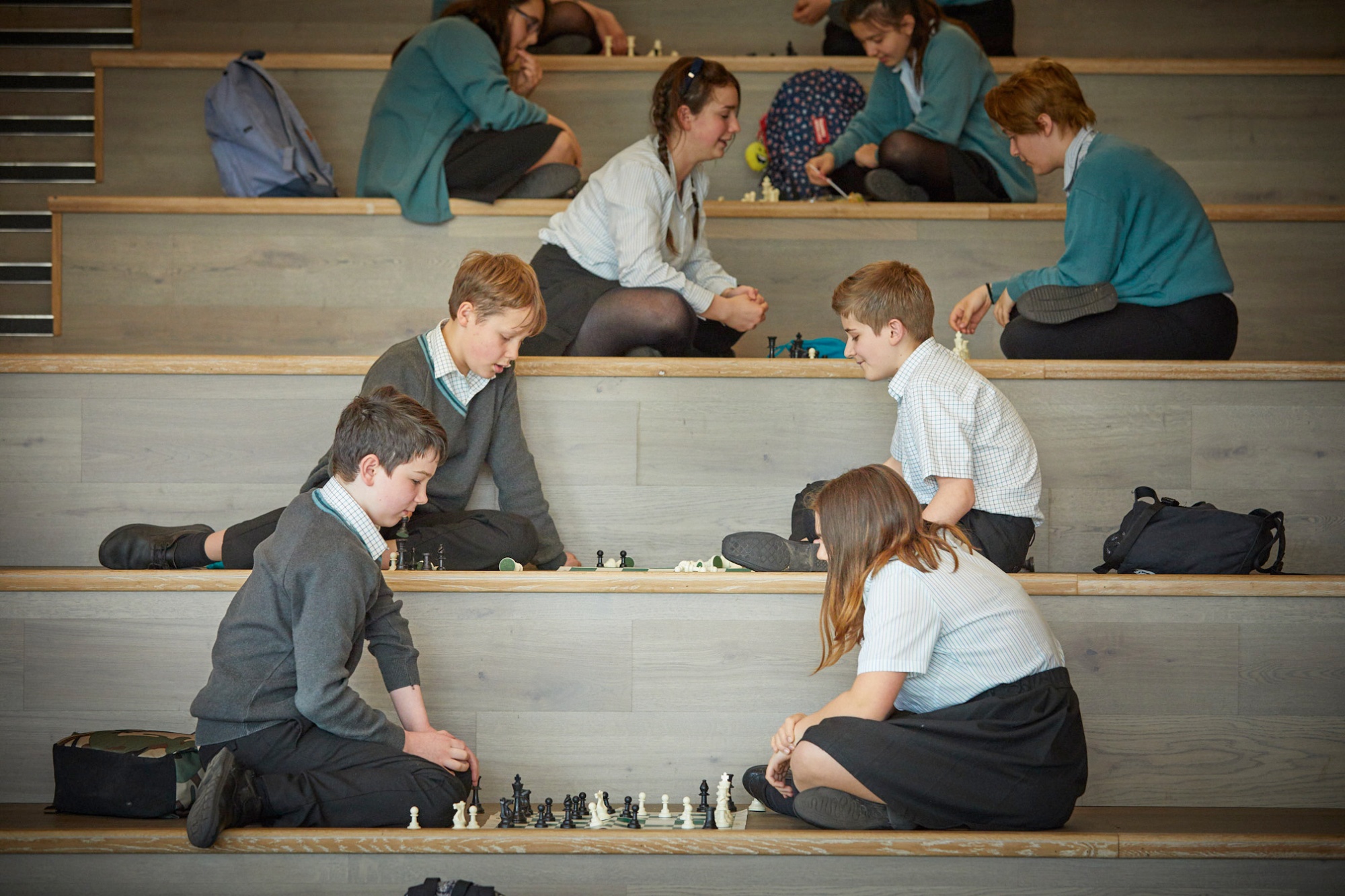 Image of students playing chess to illustrate link to 'Clubs and Activities (Y7-11)' page