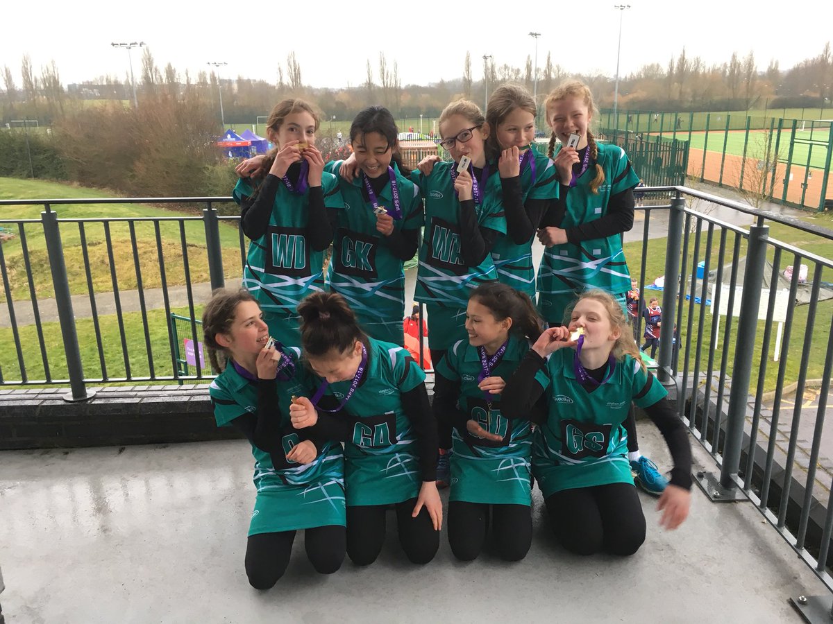 U11 netball team enjoying their regional gold medals