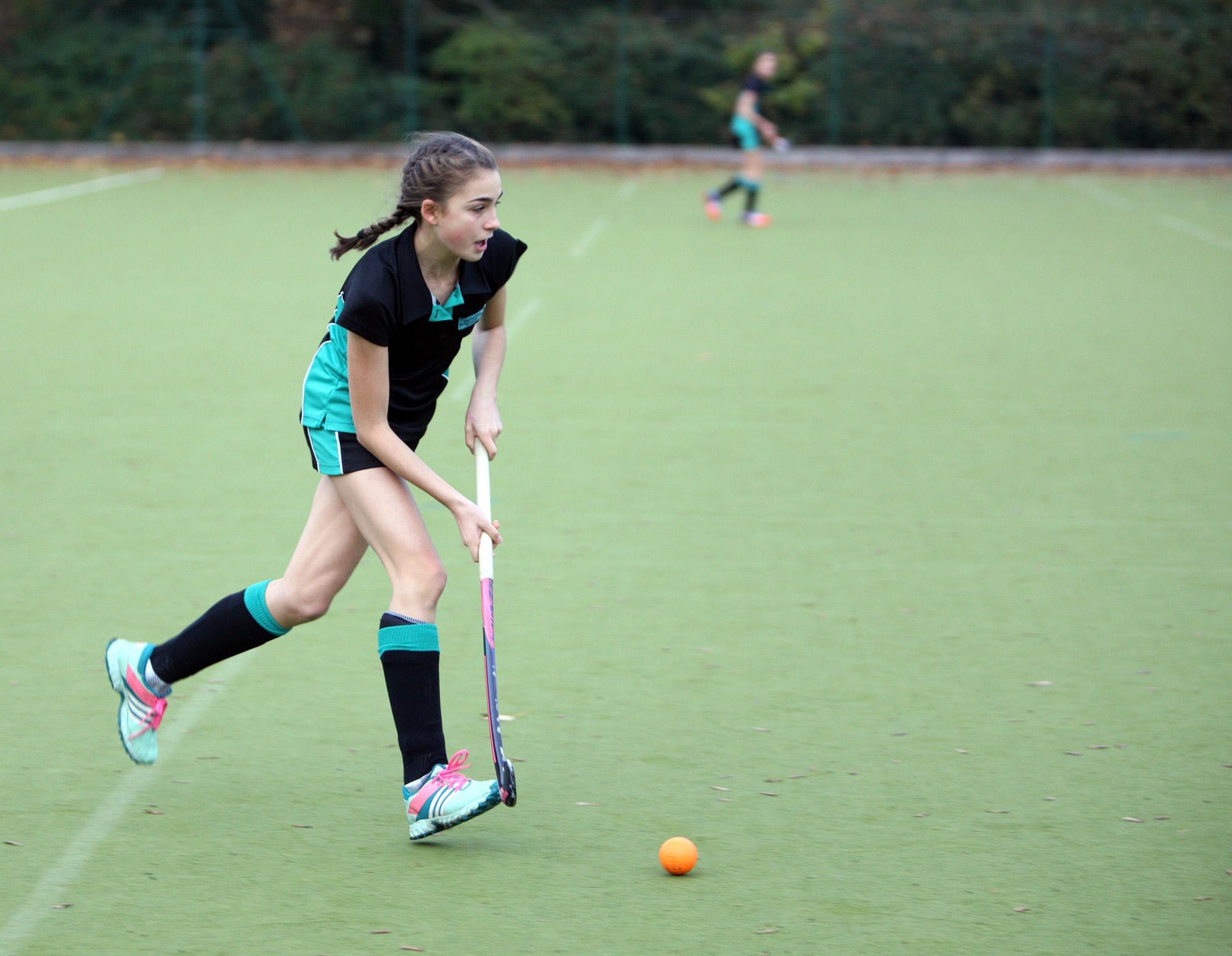 Image of student playing hockey to illustrate link to 'Curriculum and Timetable' page