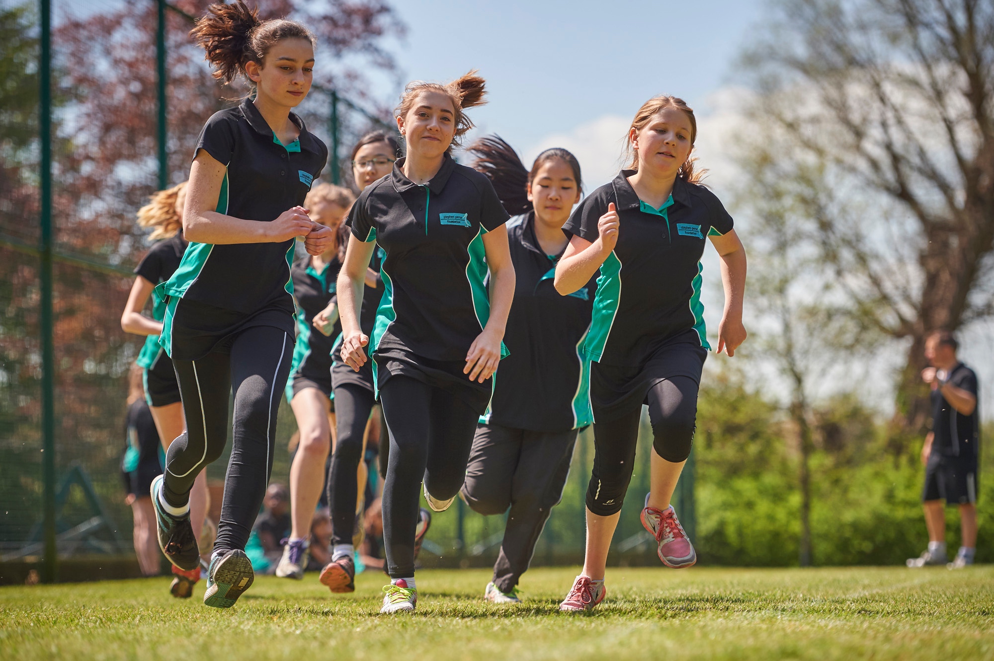 Image of students running to illustrate link to 'Sports fixtures' page
