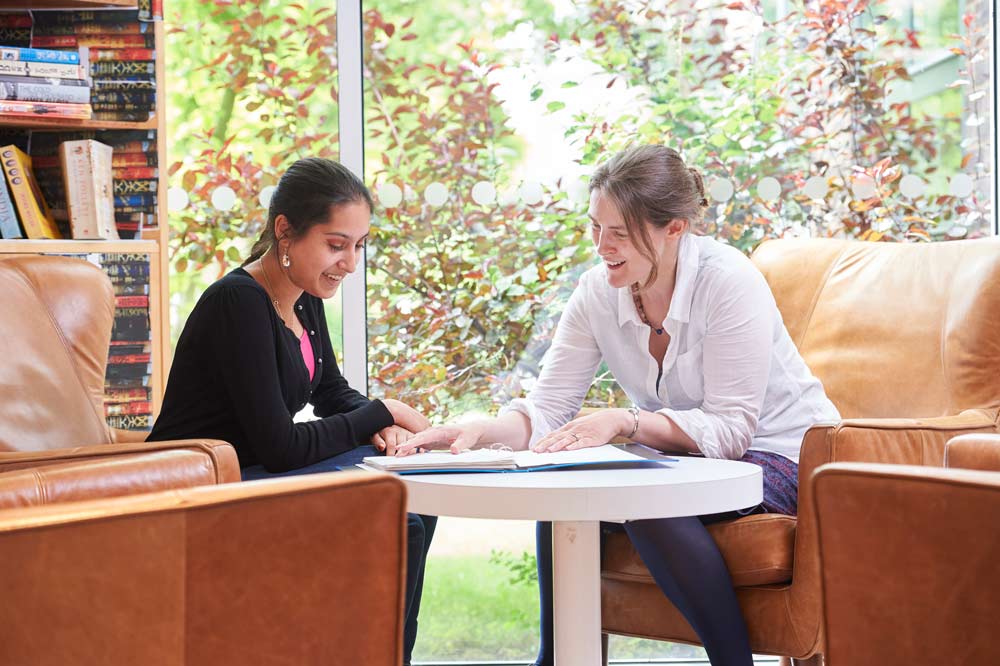 Female tutor consulting with female student