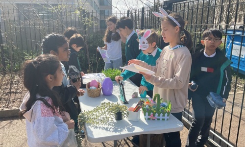 Cambridge Junior School pupils running a stall at the playground sale raising money for the House charities